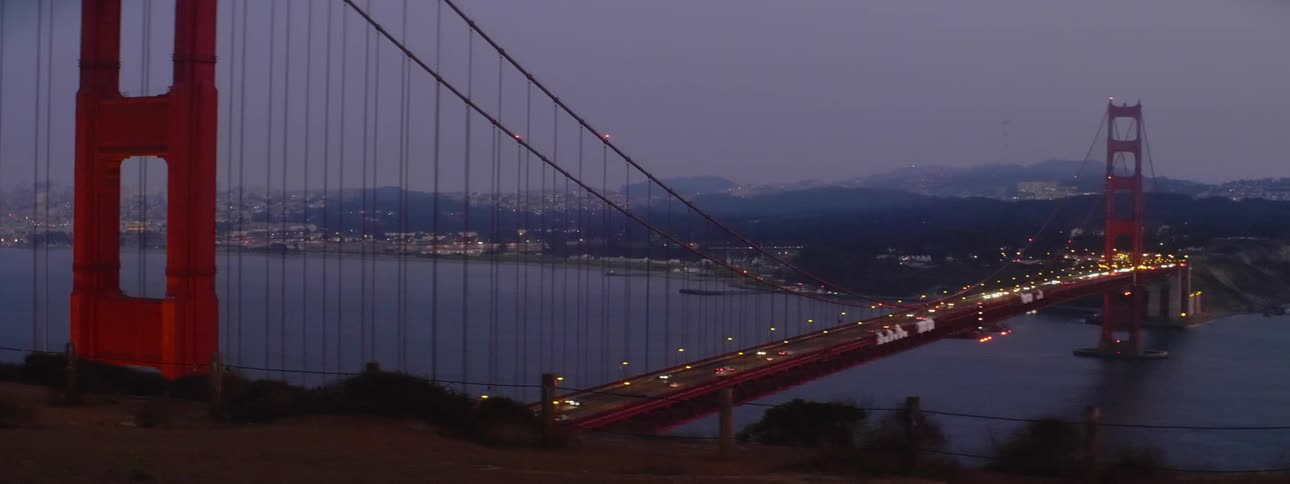 Cars drive across the golden gate bridge