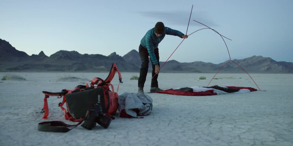 A woman assembling tent poles