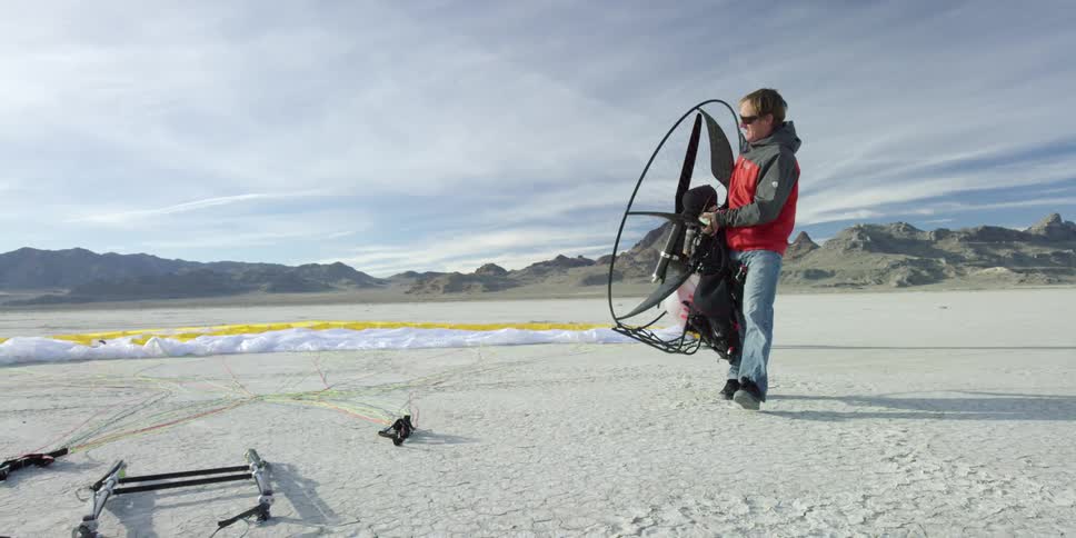 A man carries a large fan