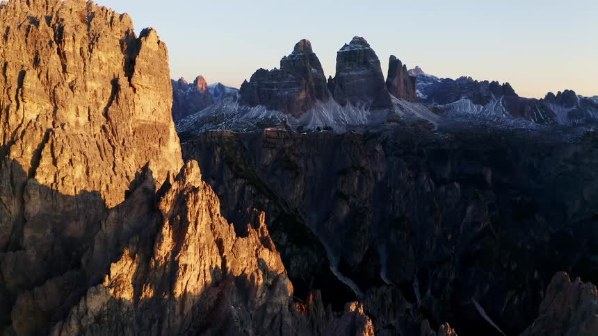 Rock formations cliffs and mountain peaks in the daytime with a canyon down below