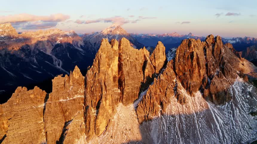 Sunlight shines on jagged mountain ridges and peaks
