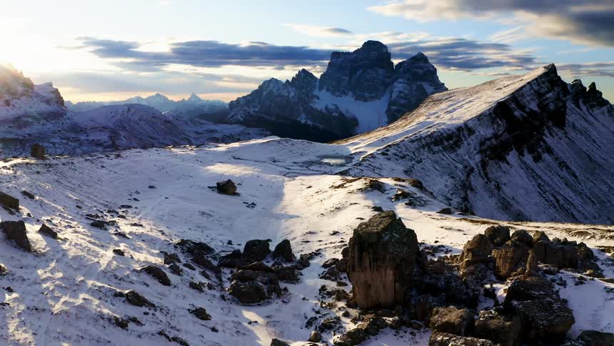 Mountain range with snow and blue skies with clouds