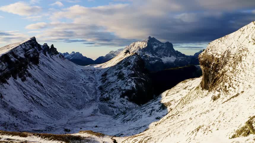 Aerial view of snow capped mountains with a valley