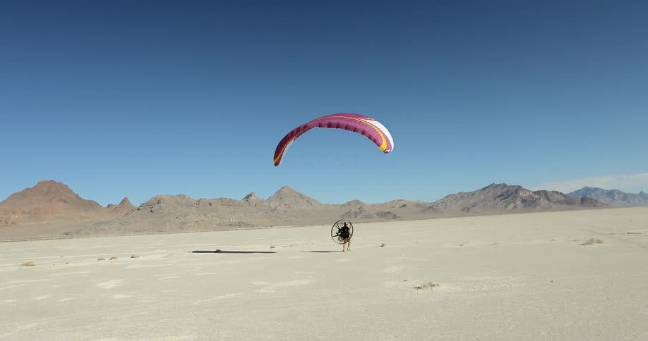 A man preparing for liftoff with a paramotor