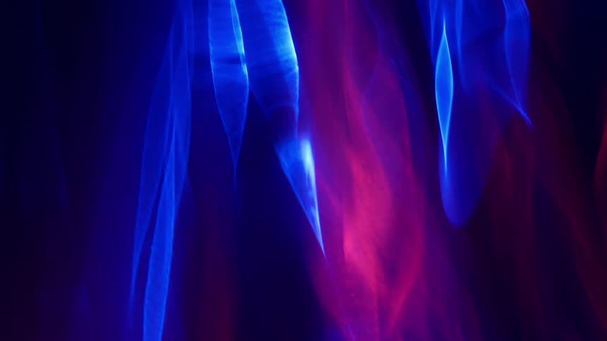 Stationary blue lights and shapes with magenta streams of color moving around