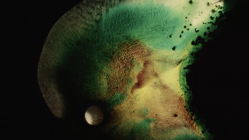 Teal brown and yellow liquids moving through a liquid