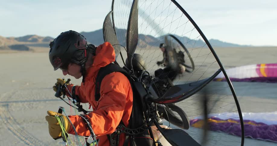 Men preparing to fly with paramotors