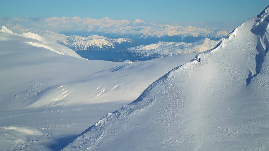 Sun shines over mountains covered in snow
