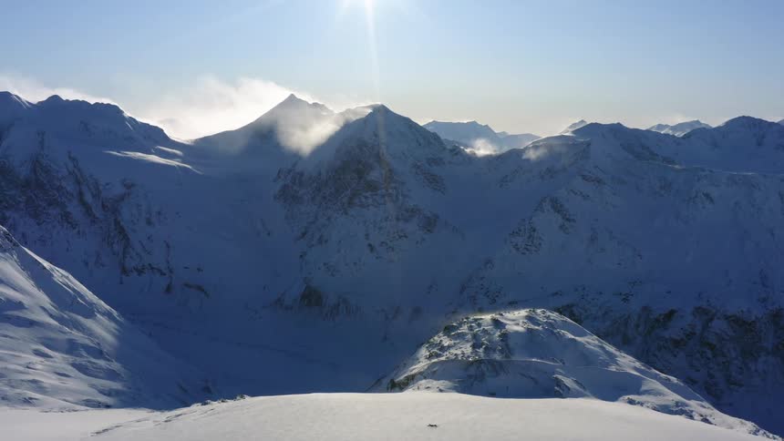 Snow covered mountain range on a sunny day
