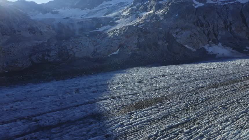 Sun shines on a valley near a mountain range