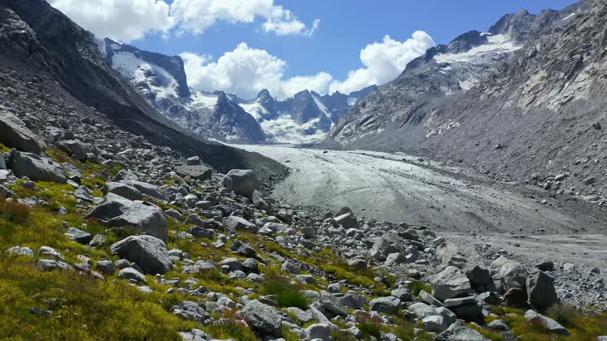 Sun shines on a valley between mountains