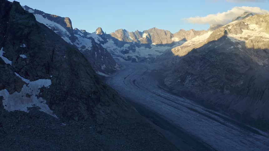 Badlands with snow covered road surrounded by mountains