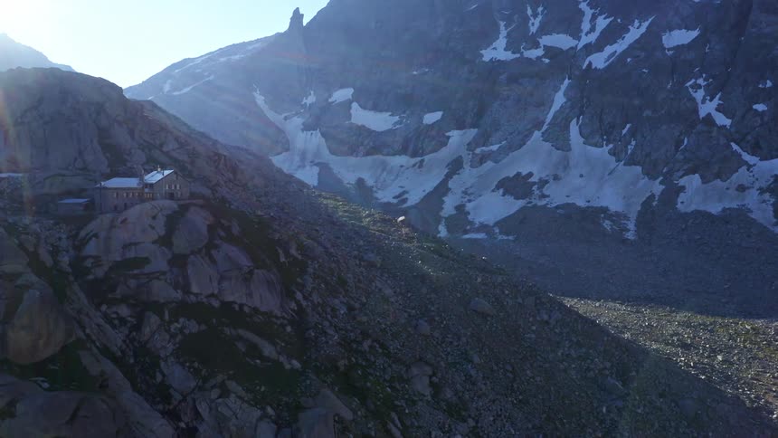 Sun shines on a valley between large rock faces