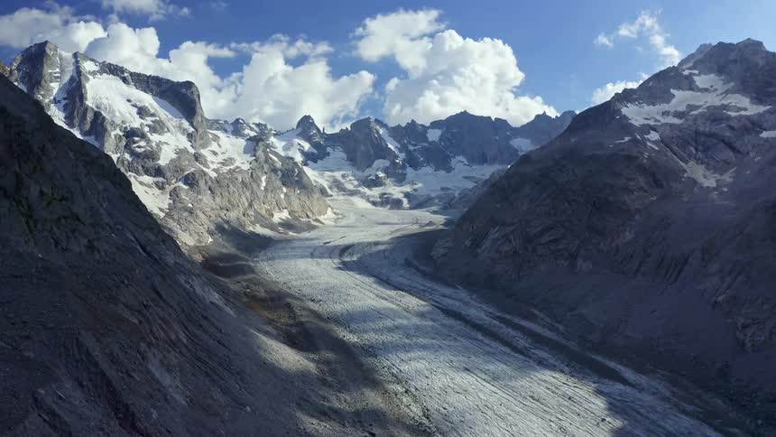 Mountain view with a road against a blue sky and clouds in the daytime