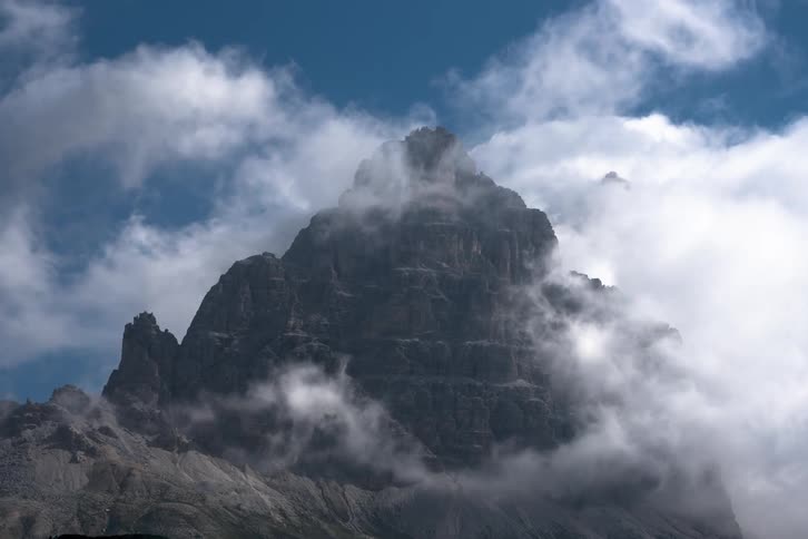 Clouds move around a large rock