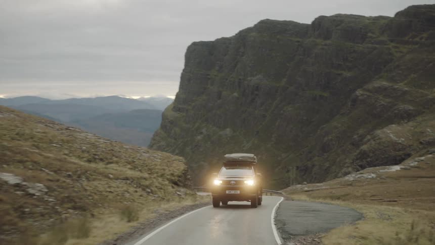 A car driving through a mountain range