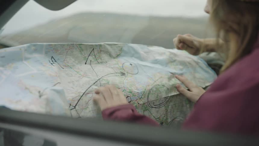 Two people look over a map while traveling