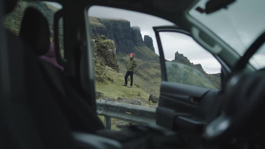 A woman grabs the map from the vehicle