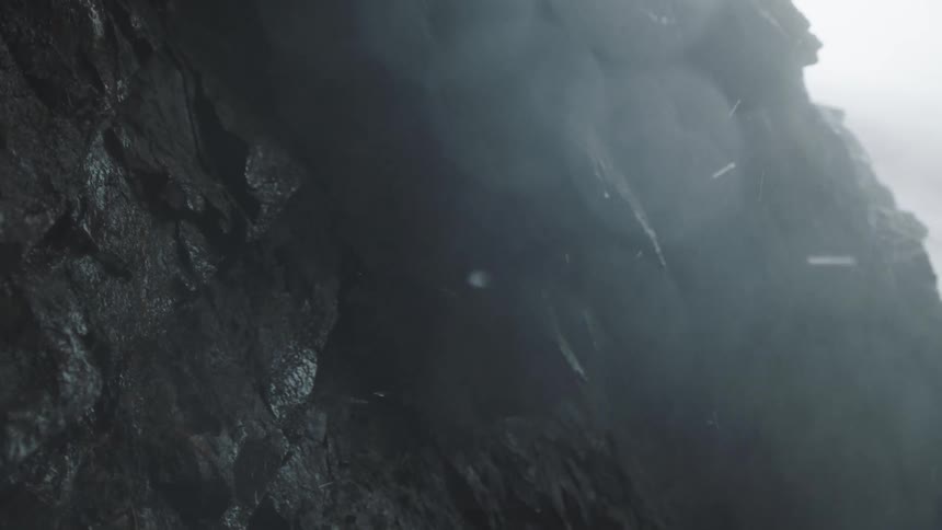 Water spraying over rocks on the shore