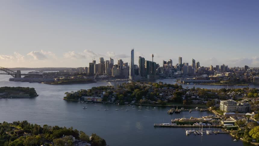 A metropolitan city filled with towering skyscrapers lines the ocean coastline