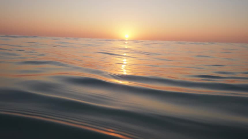 The sun sets over an ocean