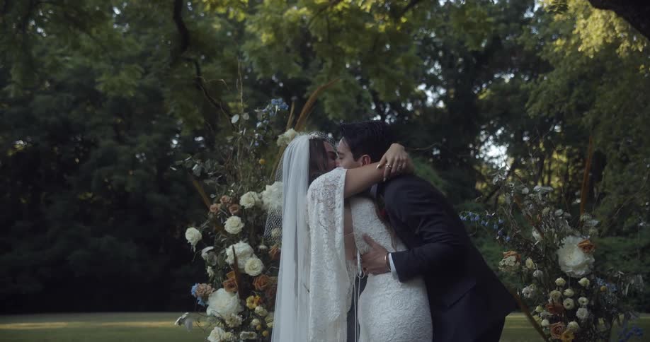 A man and woman kiss after exchanging wedding vows