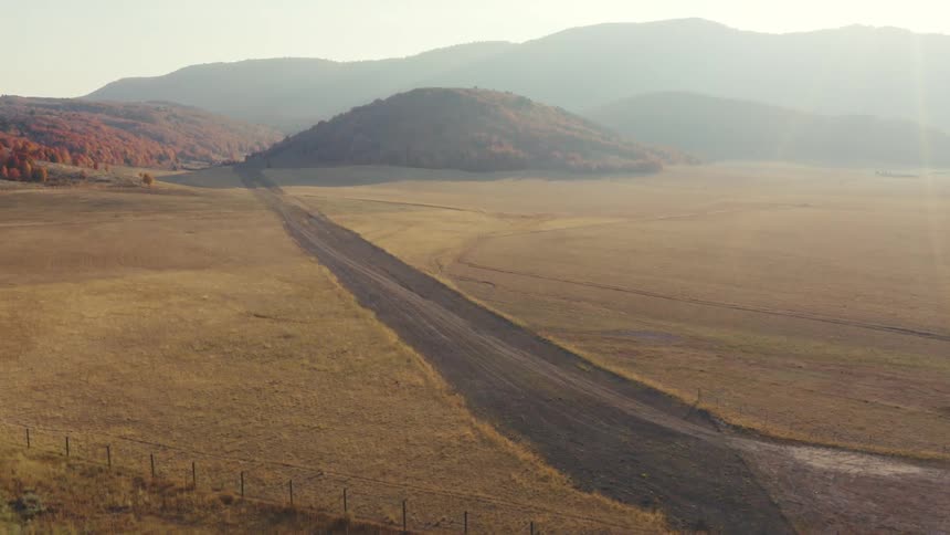 A remote road with hills in the background