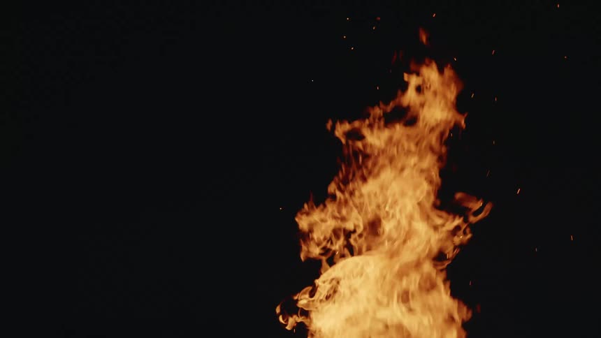 Flames burning outside at night