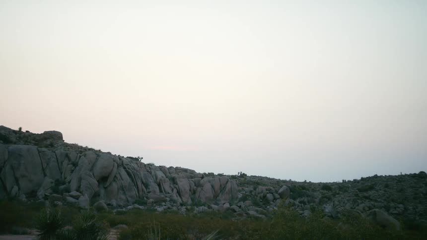 A hilly landscape covered in rock and stones on a cloudy day