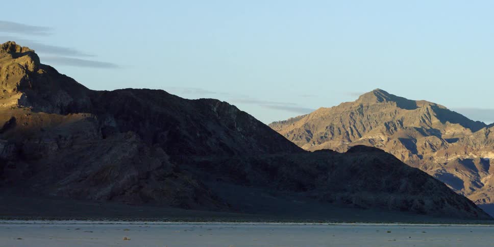 A beachside mountain in the day time