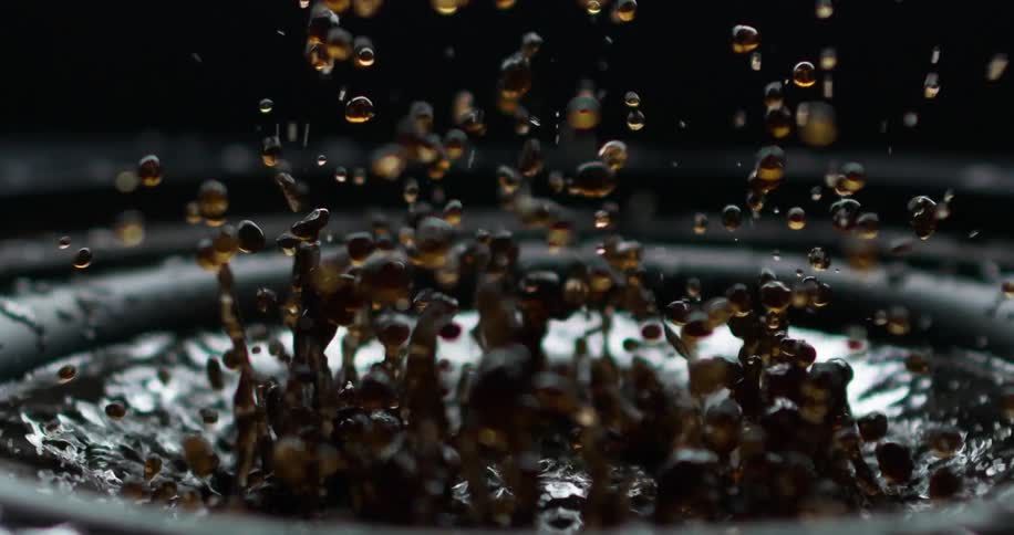 Liquid is on a surface that vibrates making it move into the air