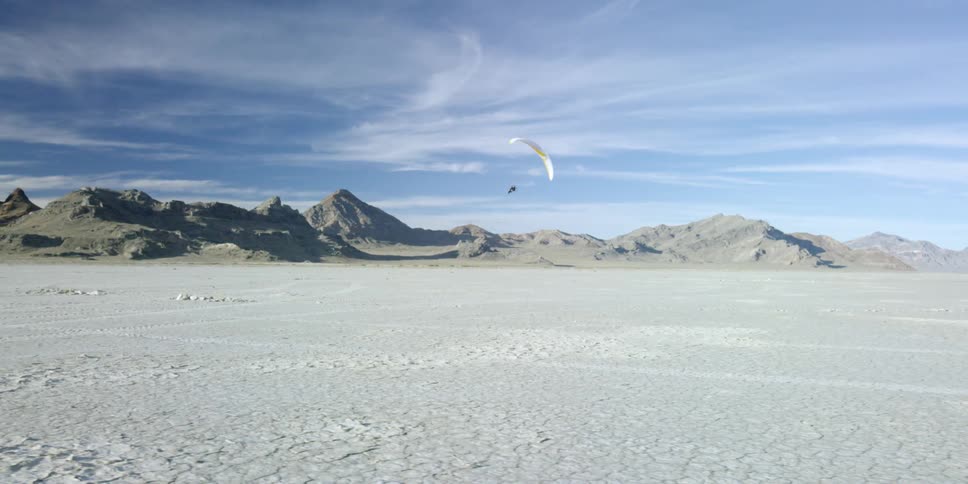 Someone using a paramotor to fly in circles