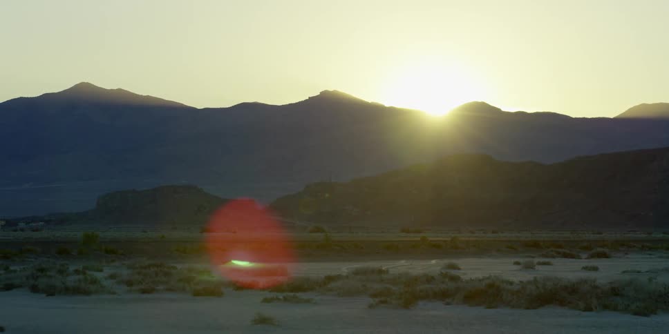 The sun rises over a mountain