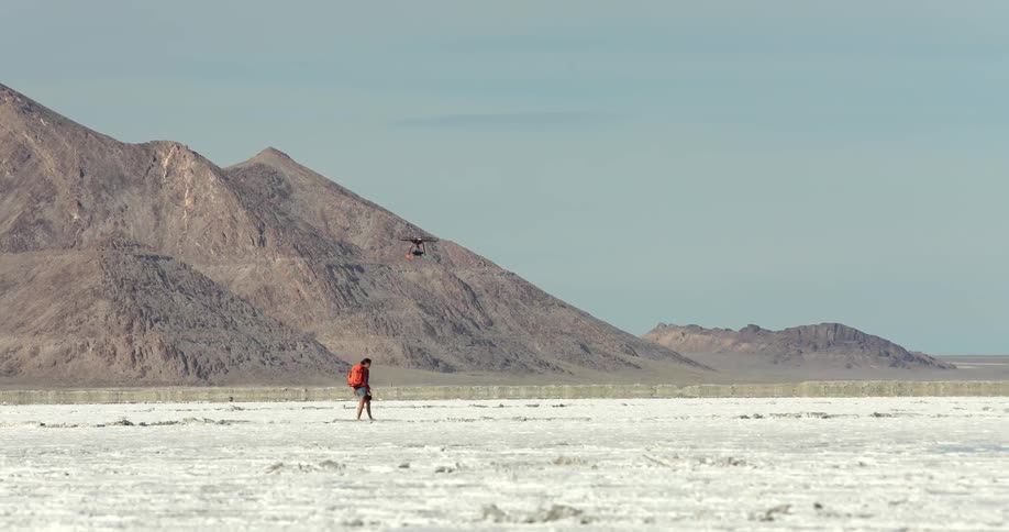 A person walks under a drone