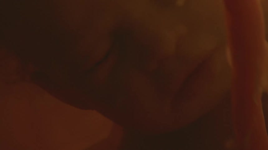 Close up of unborn babys face and umbilical cord in the womb