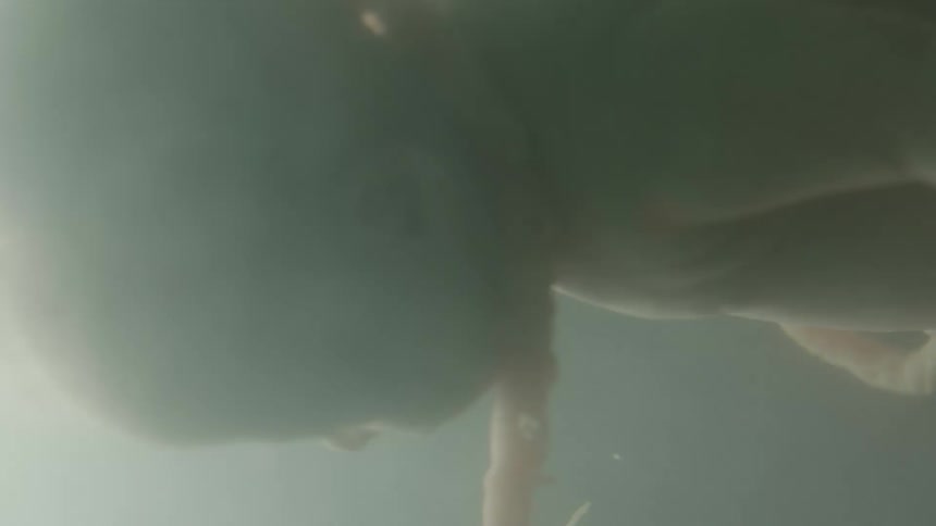 A fetus floating in utero in the dark