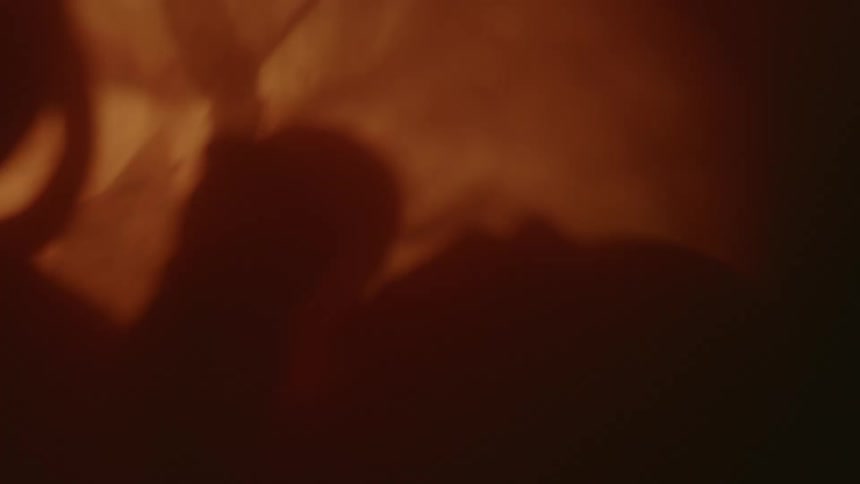 A baby in profile with hand visible with shadows and light and dark