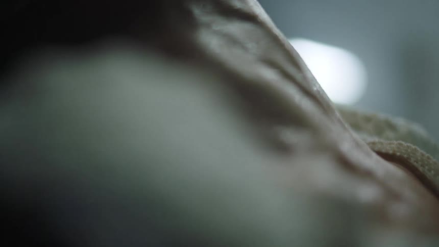 A woman strains and pants as she pushes trying to give birth