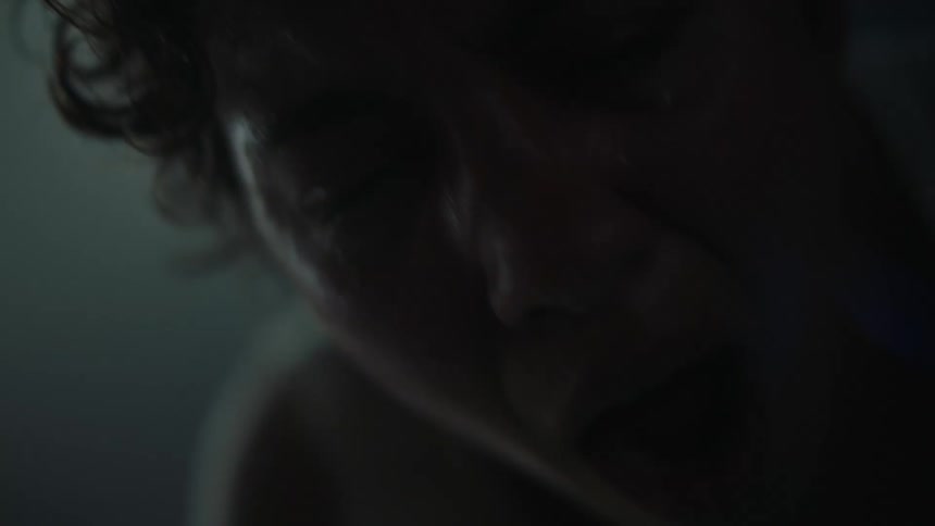 Person crying in a dark room