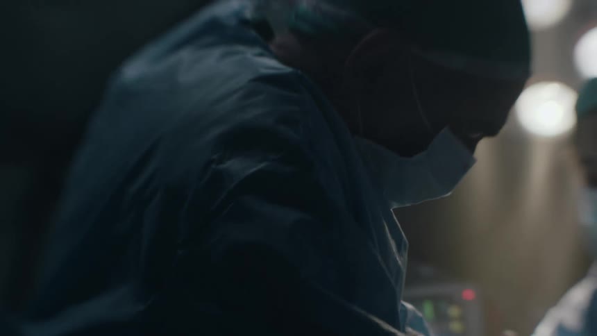 An obstetrician performing a c section during surgery