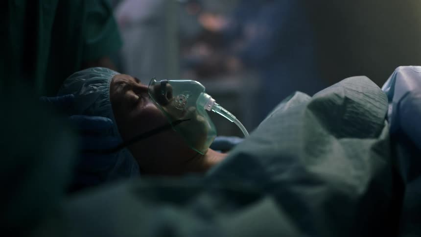 A woman is in a hospital and having surgery