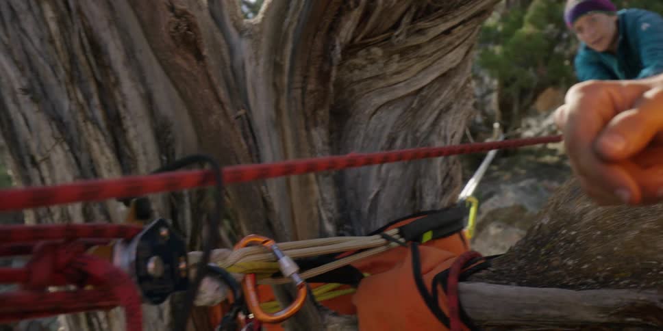 A man and woman pull on a red rope