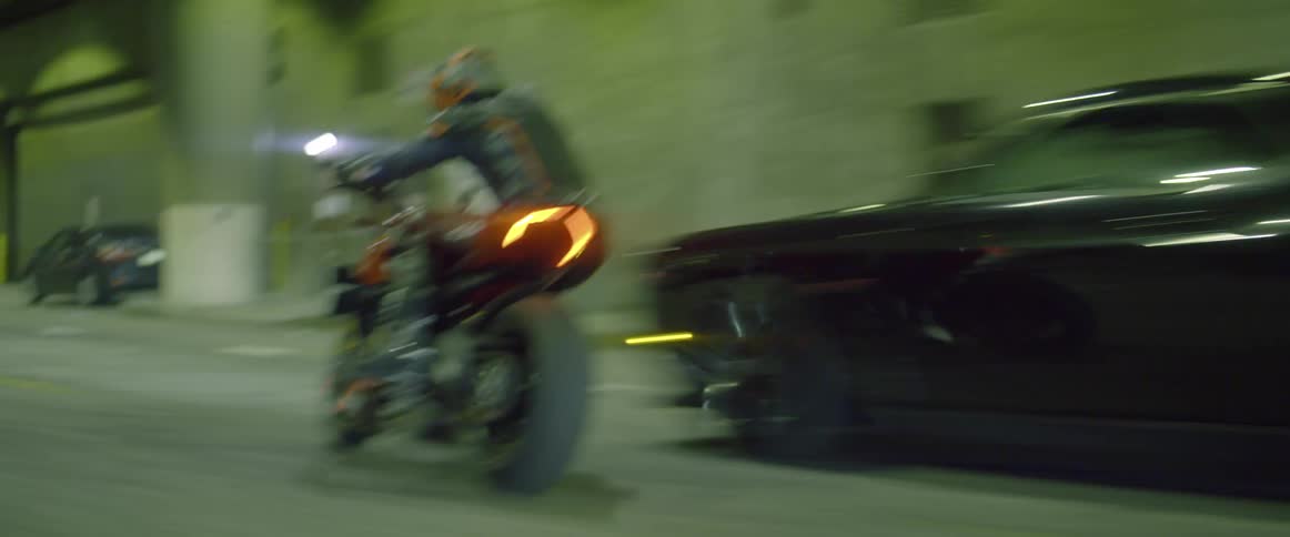 A motorcyclist weaves through traffic while speeding down a road