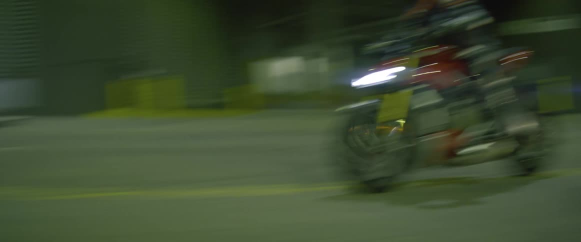 A person weaves his motorcycle in and out of traffic