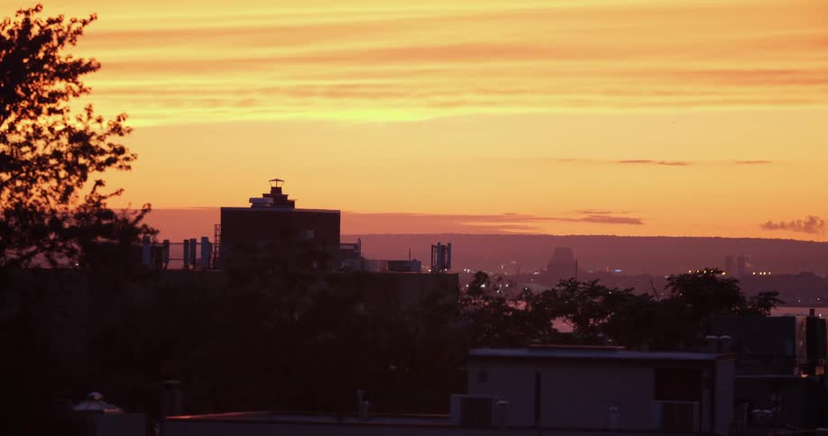 Scenic view of the yellow sunset sky over the city skyline