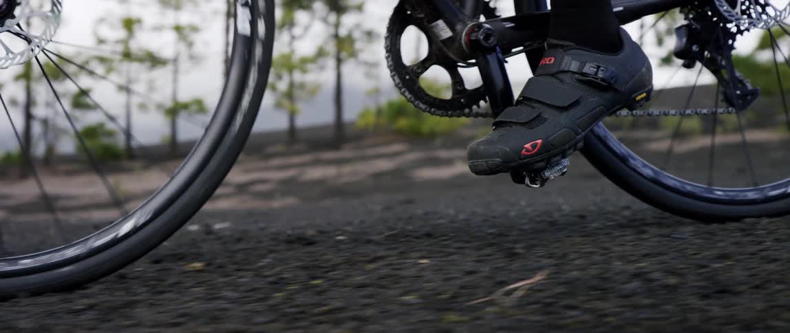 close up of high performance gravel bike riding over black gravel