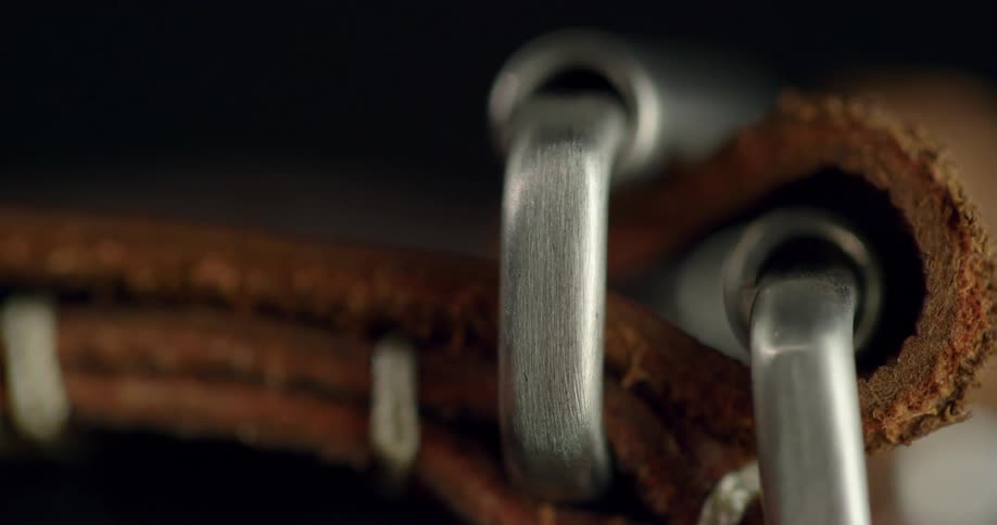Close up of a leather strap with shiny silver buckle