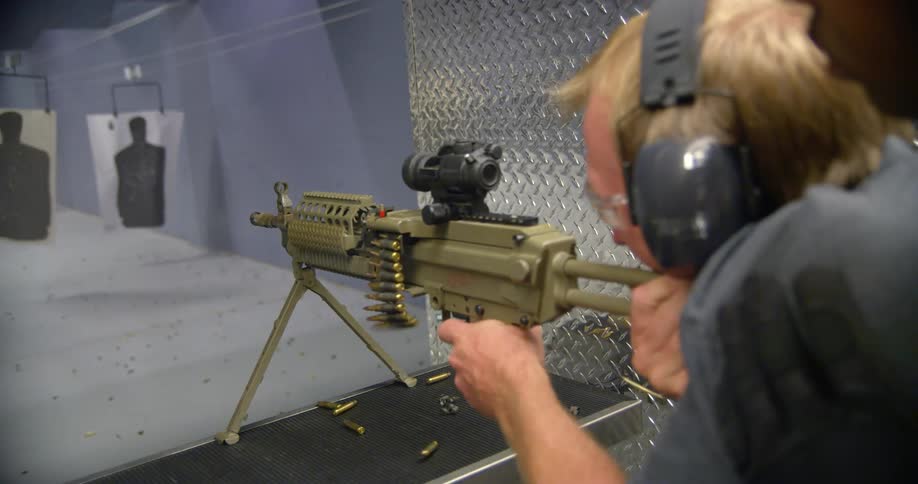 A man shooting a gun at a shooting range