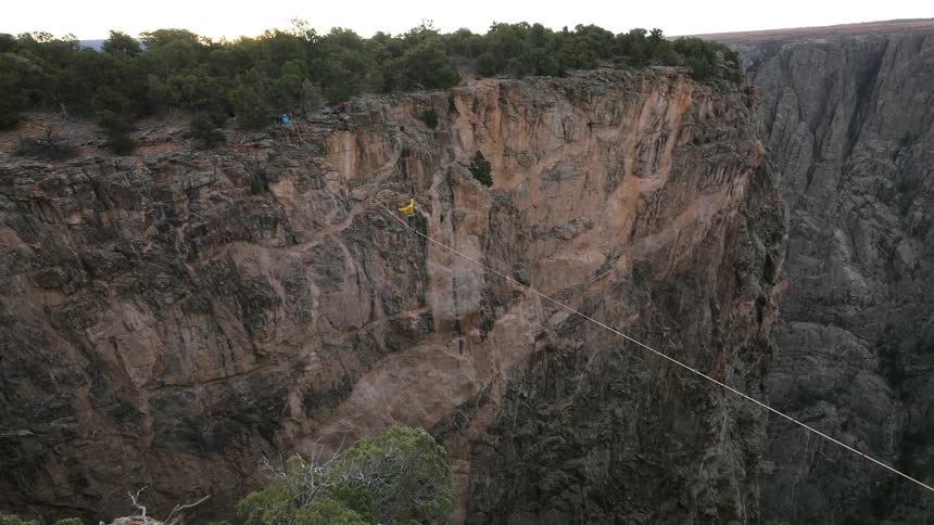 Person crossing a deep canyon on a high wire