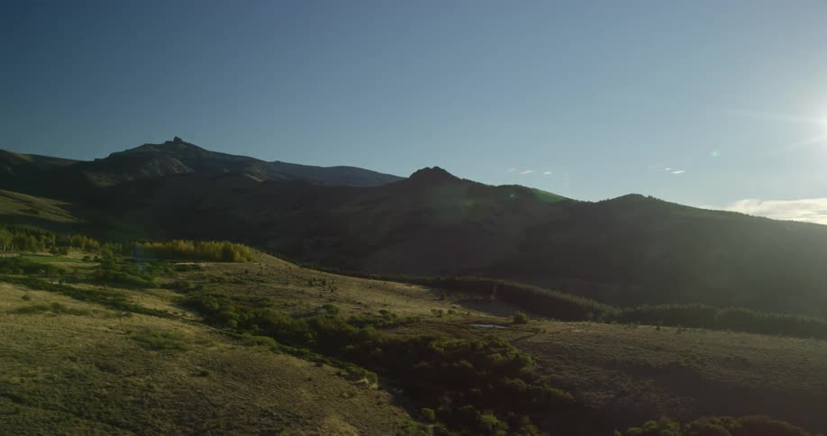 Mountain range across the grassland plains on a sunny day